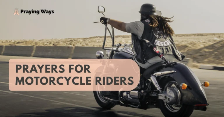 A motorcycle rider with dreadlocks and a black leather vest riding on a desert highway.
