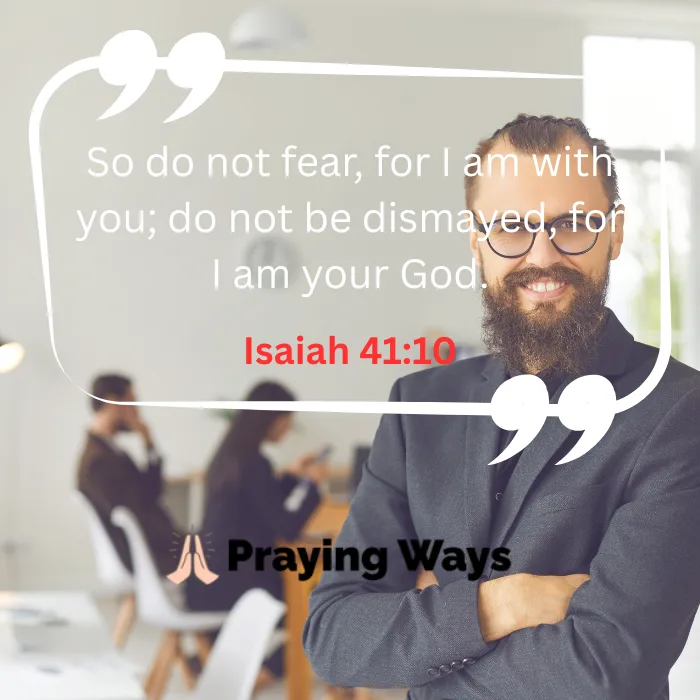 A smiling, bearded man with glasses in a gray suit stands with arms crossed in a brightly lit office setting. A large white quote graphic encloses the scripture text: "So do not fear, for I am with you; do not be dismayed, for I am your God. Isaiah 41:10" written in white and red font.
