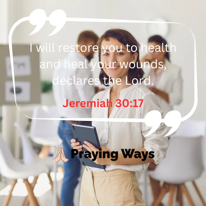 A smiling woman holding a dark notebook stands in a bright, modern office space with colleagues blurred in the background. Overlaid is a white quote frame displaying the text: "I will restore you to health and heal your wounds, declares the Lord. Jeremiah 30:17" in white and red lettering.