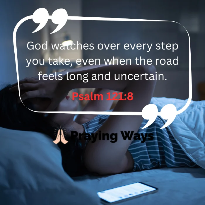 A woman lying in bed in a dimly lit, blue-toned room, holding her head in distress as she struggles with nighttime anxiety. A smartphone sits illuminated on the mattress beside her. Overlaid in a white quote bubble is the text: "God watches over every step you take, even when the road feels long and uncertain." followed by "Psalm 121:8" in red.